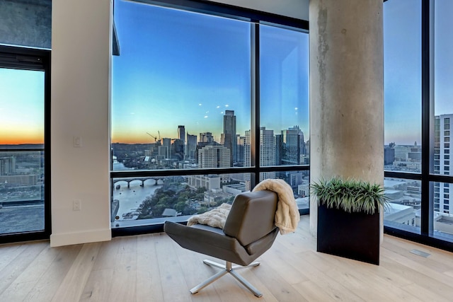 living area featuring floor to ceiling windows and hardwood / wood-style floors