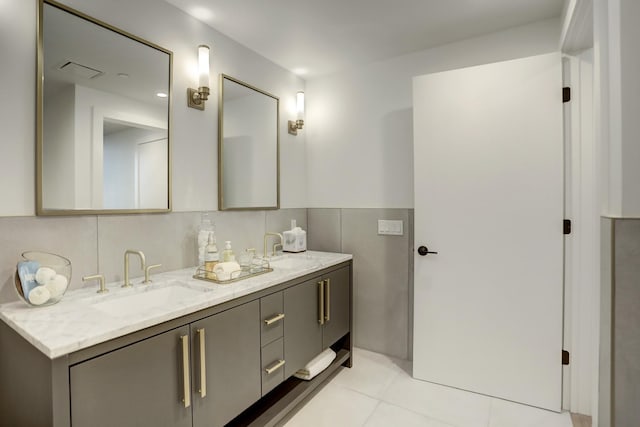 bathroom with tile walls, tile patterned floors, and vanity