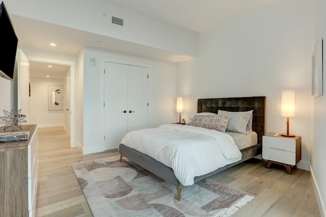 bedroom featuring a closet and light wood-type flooring