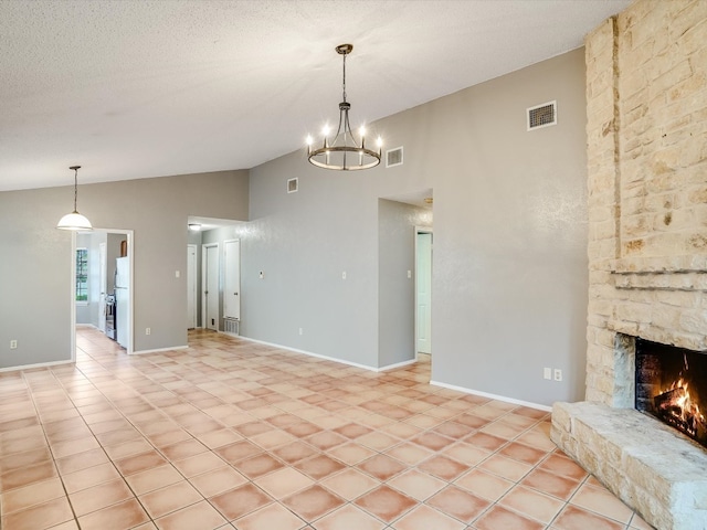 unfurnished living room featuring high vaulted ceiling, a chandelier, a textured ceiling, and a fireplace