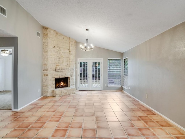 3606 Lovage Dr, Austin, TX 78727 - unfurnished living room with vaulted ceiling, a chandelier, a fireplace, a textured ceiling, and french doors