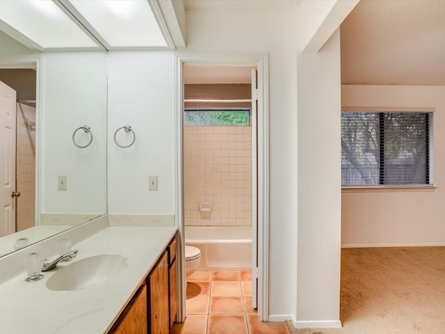 full bathroom featuring toilet, vanity, a wealth of natural light, and tile patterned flooring