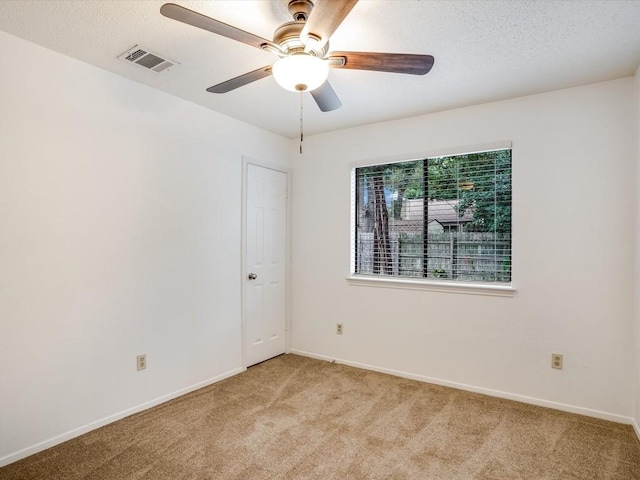 3606 Lovage Dr, Austin, TX 78727 - empty room with light carpet, a ceiling fan, and a textured ceiling