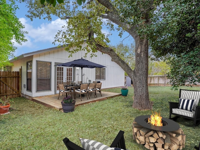 exterior space with a fire pit and a deck