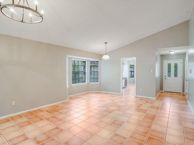 unfurnished dining area with a chandelier, lofted ceiling, a textured ceiling, and light tile patterned floors