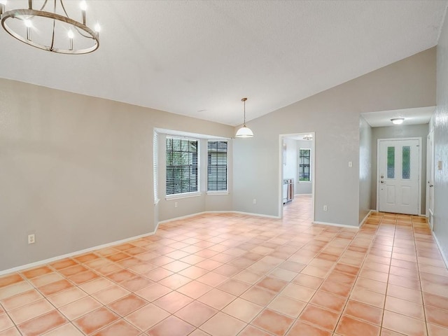 3606 Lovage Dr, Austin, TX 78727 - unfurnished room with vaulted ceiling, light tile patterned floors, and a chandelier