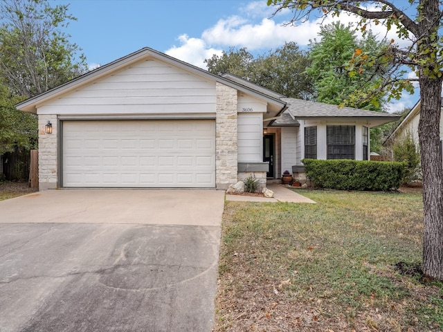 ranch-style house featuring a garage and a front lawn