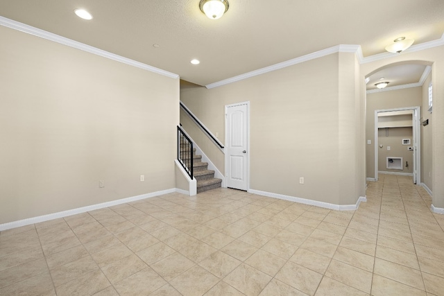 spare room featuring light tile patterned floors and ornamental molding