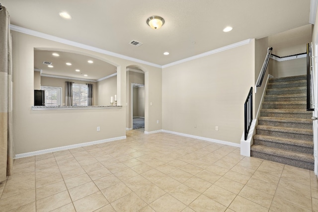 unfurnished living room featuring light tile patterned floors and crown molding