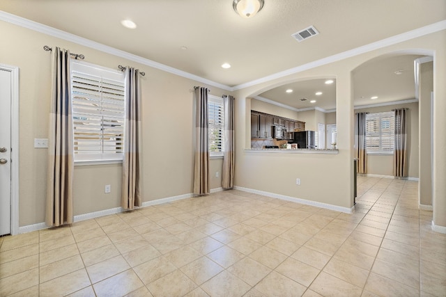 interior space featuring black refrigerator, crown molding, dark brown cabinetry, light tile patterned floors, and kitchen peninsula