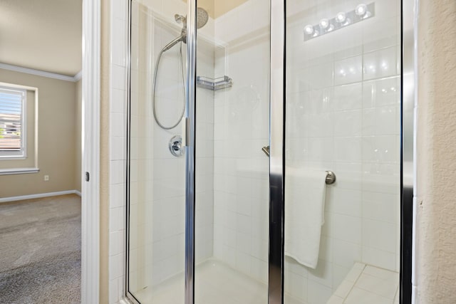 bathroom featuring a shower with shower door and ornamental molding