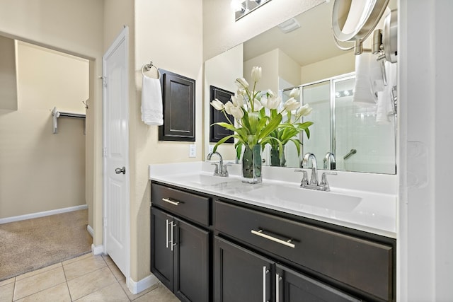 bathroom featuring tile patterned flooring, vanity, and walk in shower