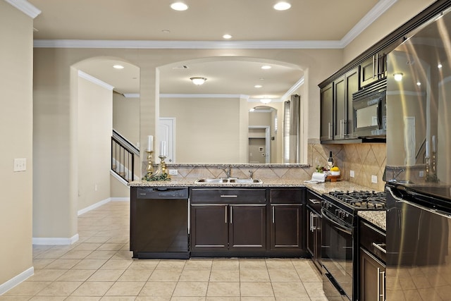 kitchen with black appliances, sink, light tile patterned floors, ornamental molding, and light stone counters