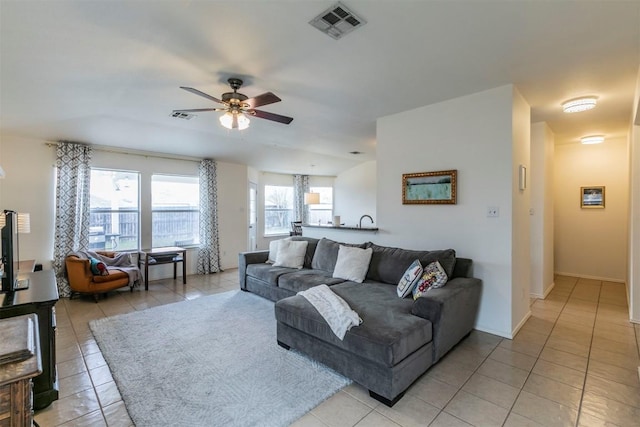 tiled living room with ceiling fan