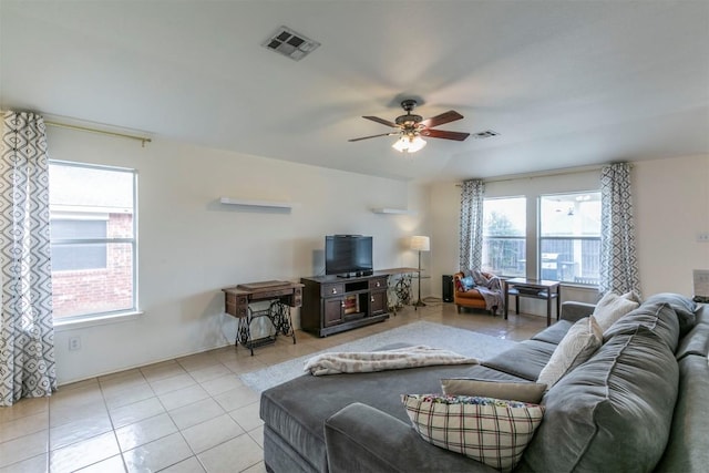 living room with ceiling fan and light tile patterned flooring