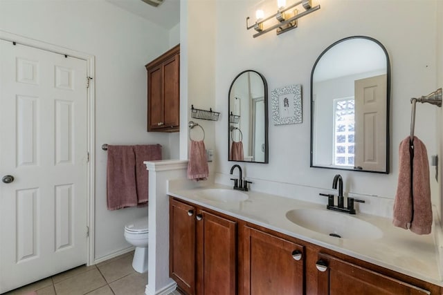 bathroom featuring toilet, vanity, and tile patterned floors