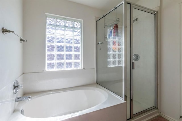 bathroom featuring separate shower and tub