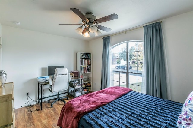 bedroom with hardwood / wood-style floors and ceiling fan