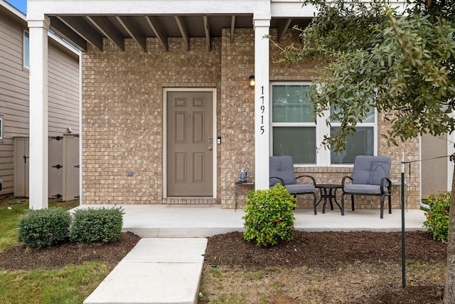 view of exterior entry featuring a patio