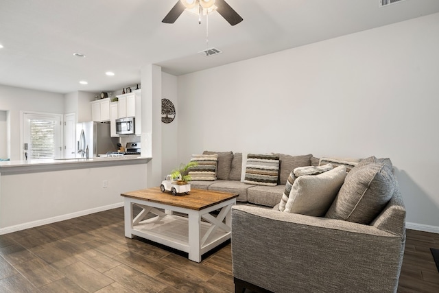 living room featuring dark hardwood / wood-style floors and ceiling fan