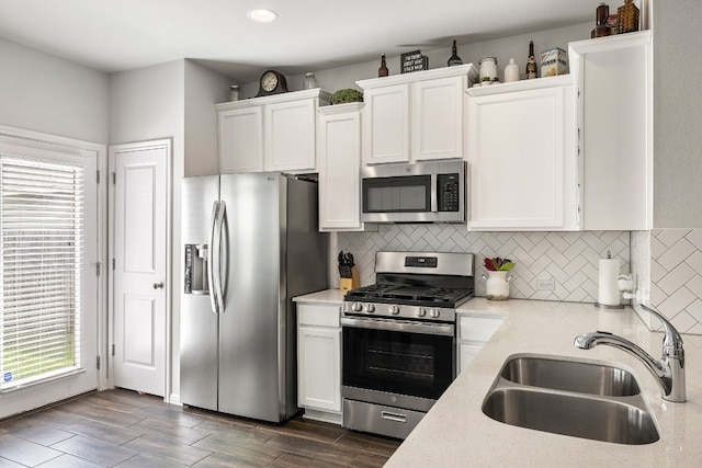 kitchen featuring white cabinetry, sink, decorative backsplash, and stainless steel appliances