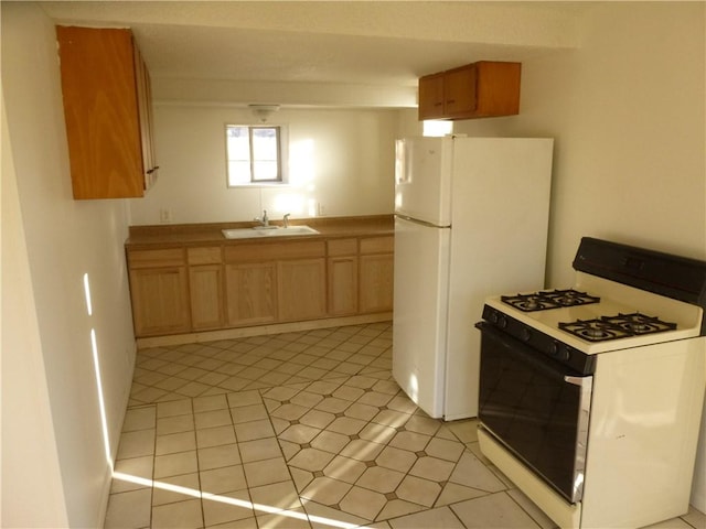 7403 Guadalupe St, Austin, TX 78752 - kitchen featuring white appliances, a sink, light tile patterned floors, and light countertops