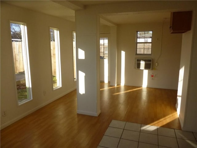 7403 Guadalupe St, Austin, TX 78752 - foyer entrance with wood finished floors, a wall unit AC, and baseboards