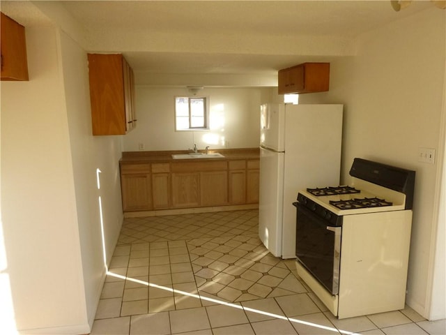 7403 Guadalupe St, Austin, TX 78752 - kitchen featuring white appliances, a sink, and light tile patterned flooring