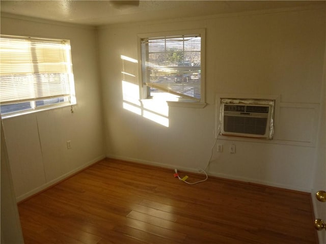 7403 Guadalupe St, Austin, TX 78752 - unfurnished room featuring a wall mounted air conditioner, hardwood / wood-style flooring, baseboards, and ornamental molding