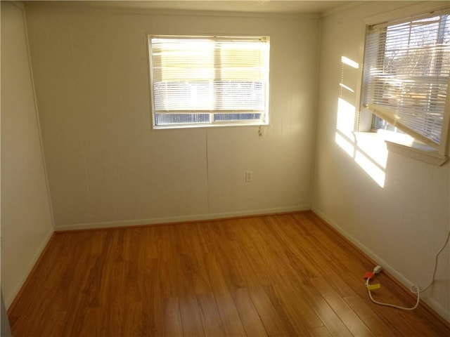 7403 Guadalupe St, Austin, TX 78752 - empty room with light wood finished floors, healthy amount of natural light, baseboards, and ornamental molding