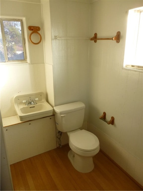 bathroom with toilet, sink, and hardwood / wood-style floors