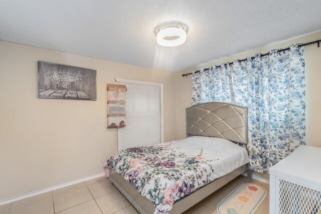 bedroom with light tile patterned floors