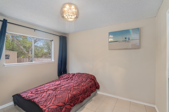 tiled bedroom featuring a textured ceiling