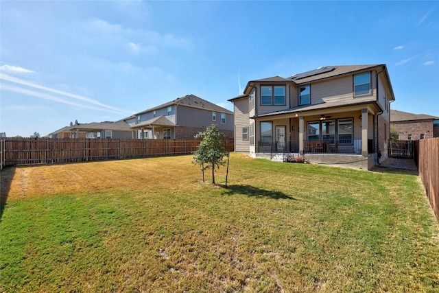 back of house with ceiling fan, a patio, and a yard