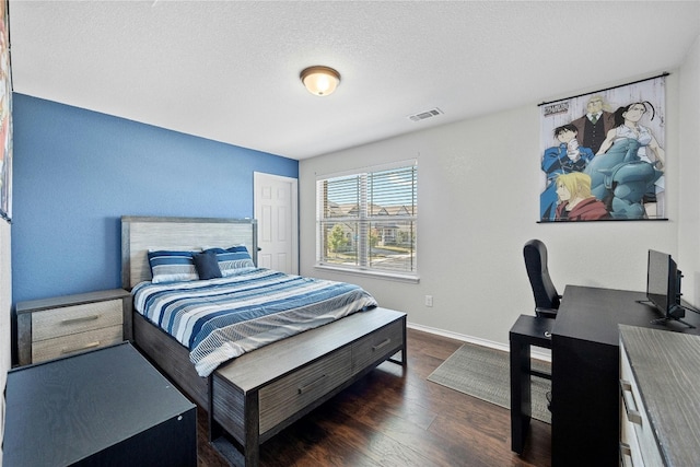 bedroom featuring dark hardwood / wood-style floors and a textured ceiling