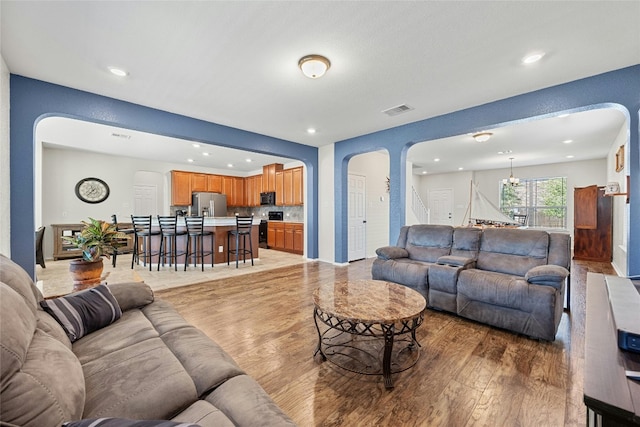 living room with a chandelier and hardwood / wood-style floors