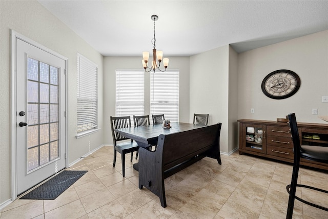 tiled dining space with a notable chandelier