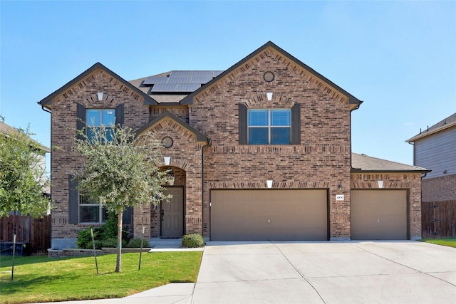 view of front of home featuring brick siding, solar panels, fence, concrete driveway, and a front yard