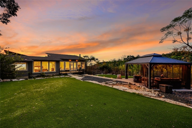 yard at dusk with a gazebo