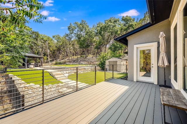 wooden deck featuring a gazebo and a yard