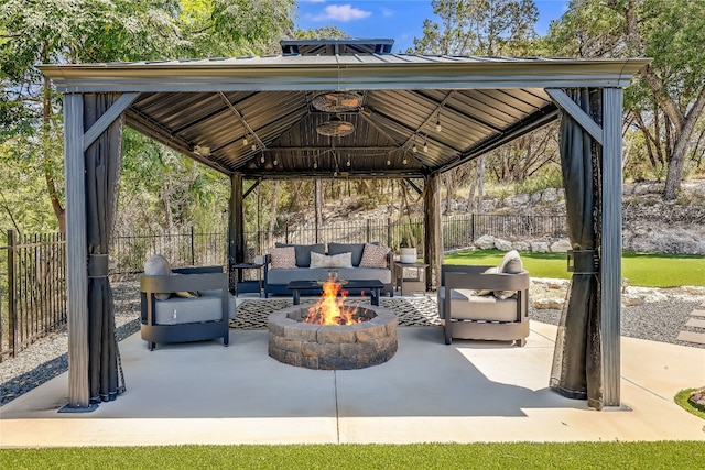 view of patio featuring a gazebo and an outdoor living space with a fire pit