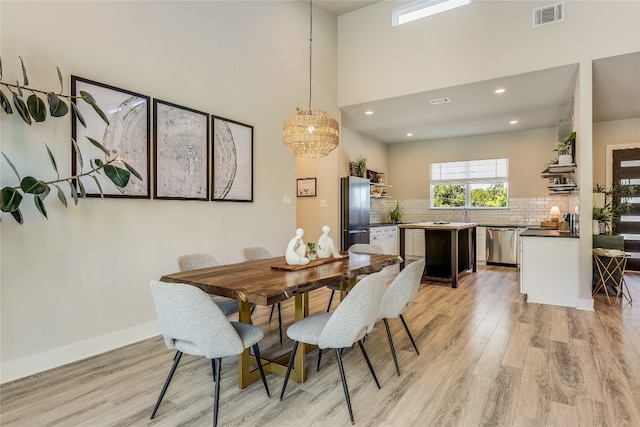 dining space featuring light wood-type flooring