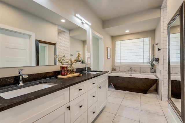 bathroom featuring shower with separate bathtub, vanity, and tile patterned floors