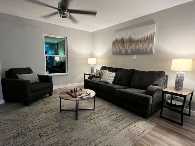 living room featuring hardwood / wood-style flooring and ceiling fan