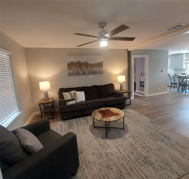 living room featuring light wood-type flooring and ceiling fan