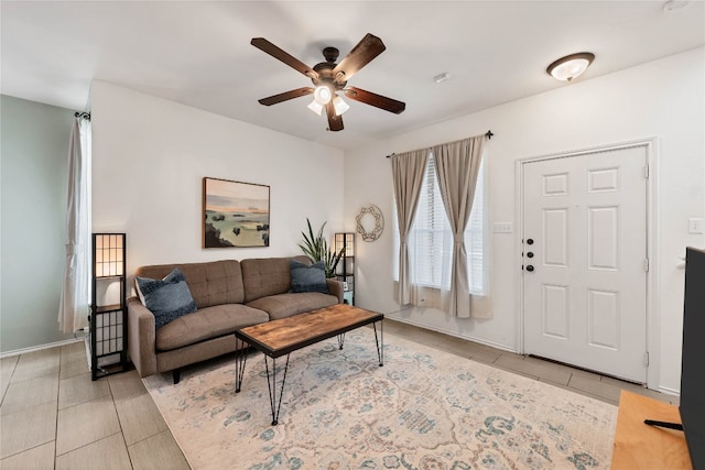 living area featuring ceiling fan and tile patterned flooring