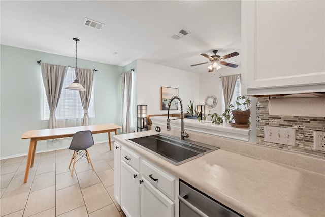 kitchen featuring pendant lighting, a healthy amount of sunlight, and white cabinetry