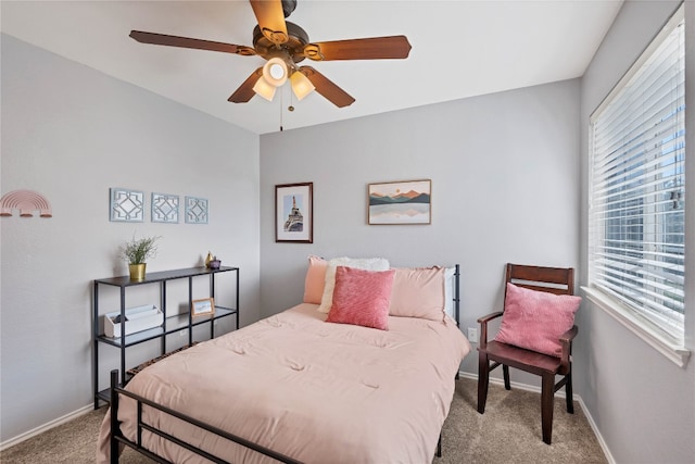 bedroom with baseboards, carpet floors, and a ceiling fan