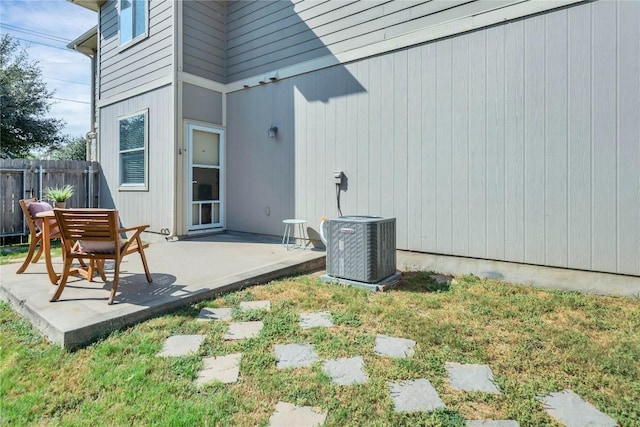 exterior space featuring central AC unit and fence