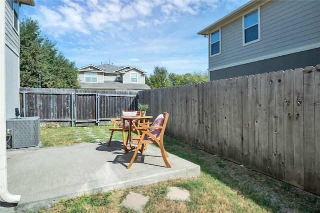 view of yard with a patio, cooling unit, and a fenced backyard